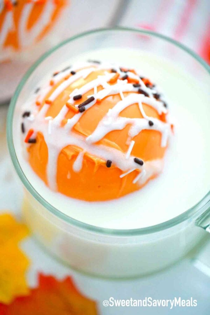 pumpkin spice hot cocoa bomb in a cup with milk