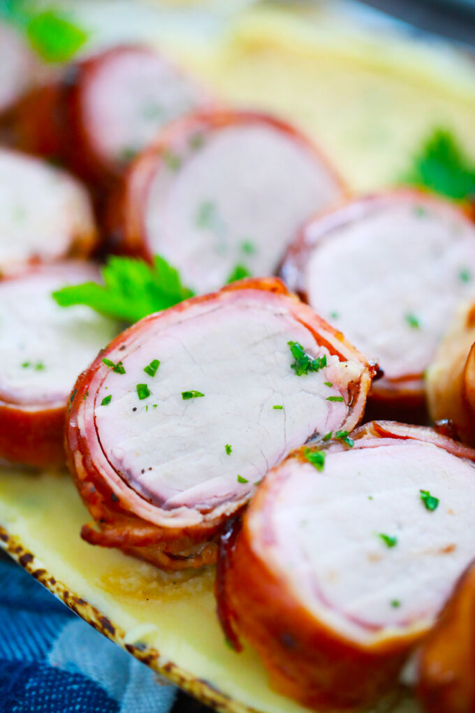 Sliced, juicy air fryer bacon wrapped pork tenderloin.