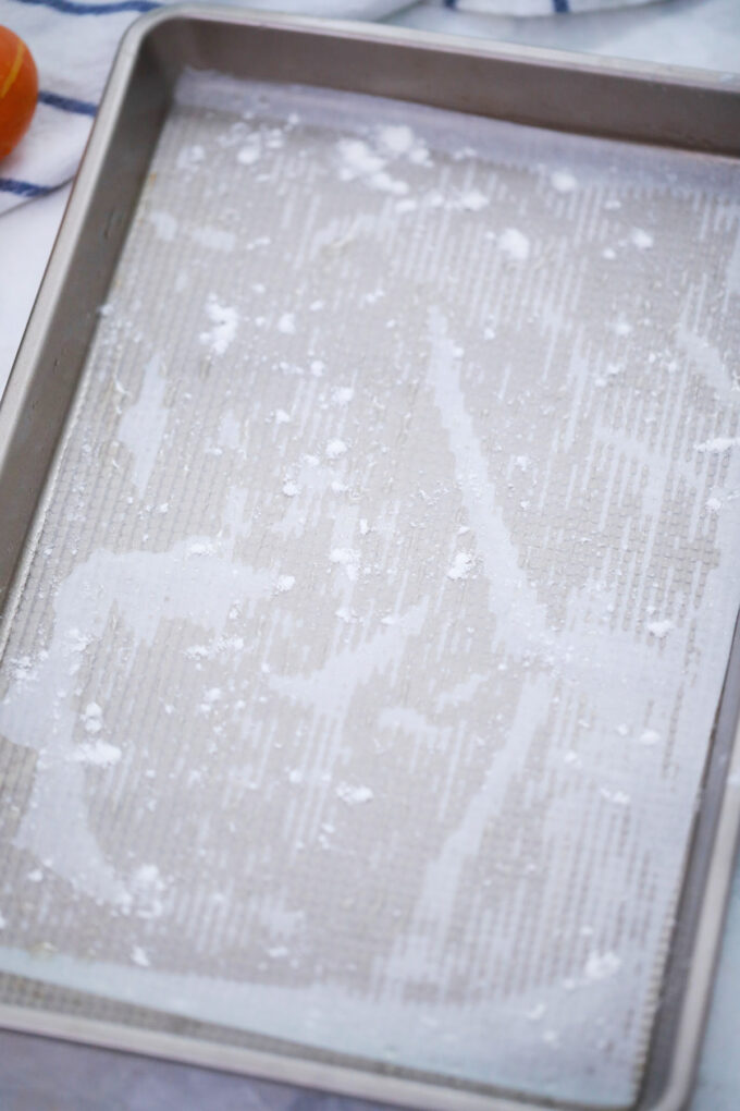 Prepping the pan for pumpkin roll.