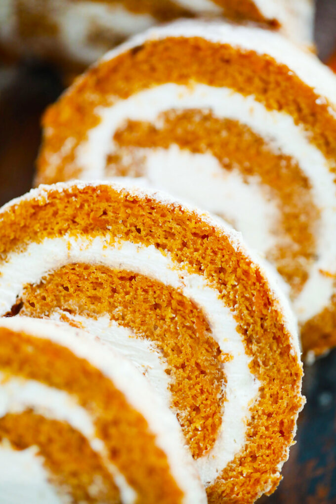 Sliced pumpkin roll with cream cheese frosting.