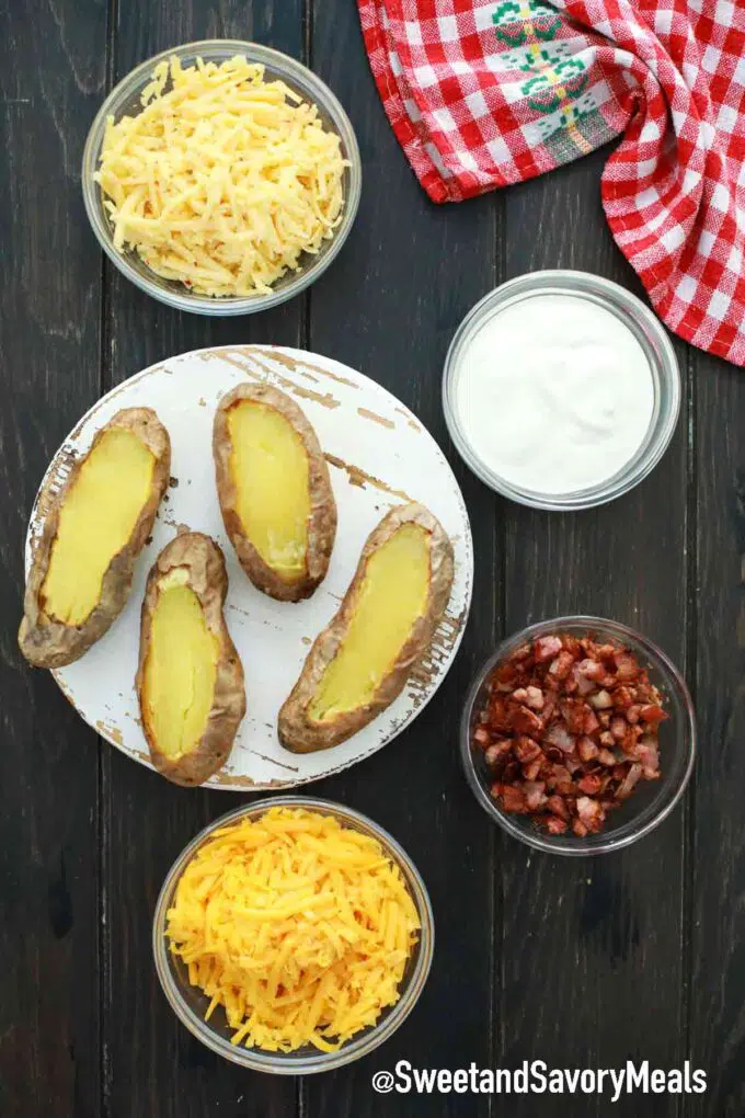 potatoes cheese sour cream and bacon on a table