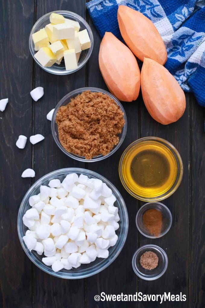 sweet potatoes, butter, brown sugar, maple syrup, marshmallows and spices on a wooden table