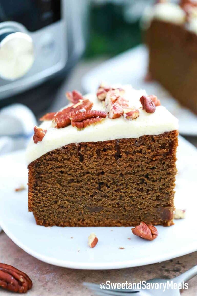 sliced instant pot gingerbread cake with frosting and pecans