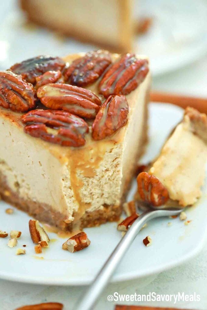 a forkful of pecan cheesecake topped with pecans