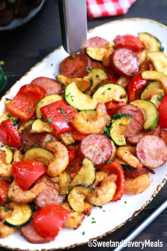 shrimp with veggies and sausage on a serving plate