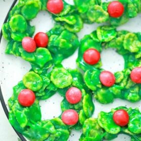 a plate of green and red christmas wreath cookies