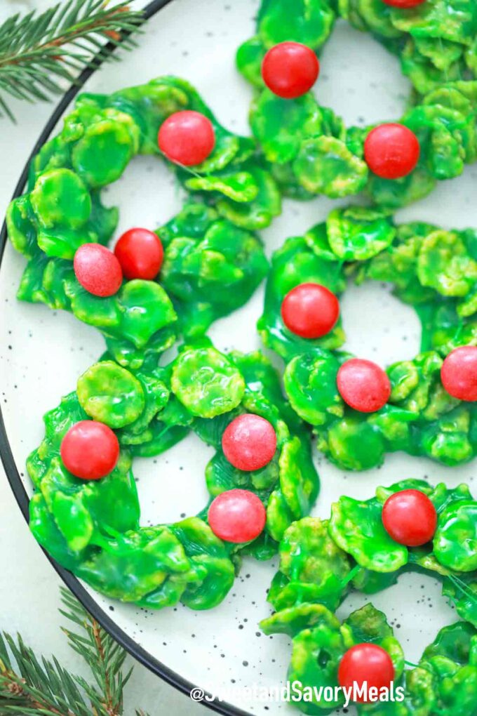 a plate of green and red christmas wreath cookies