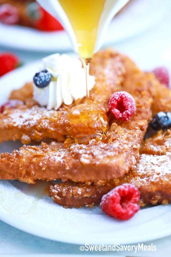 cornflakes Crusted French toast with maple syrup berries and whipped cream