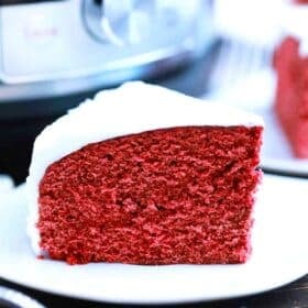 slice of instant pot red velvet cake with cream cheese frosting