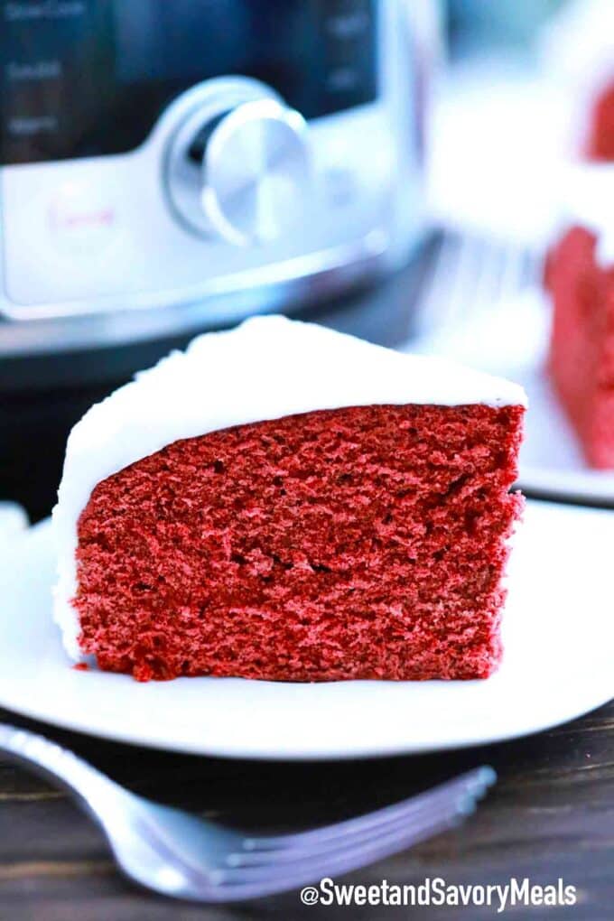 slice of instant pot red velvet cake with cream cheese frosting