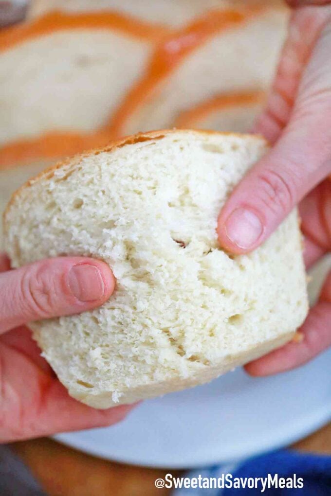 holding a slice of white bread