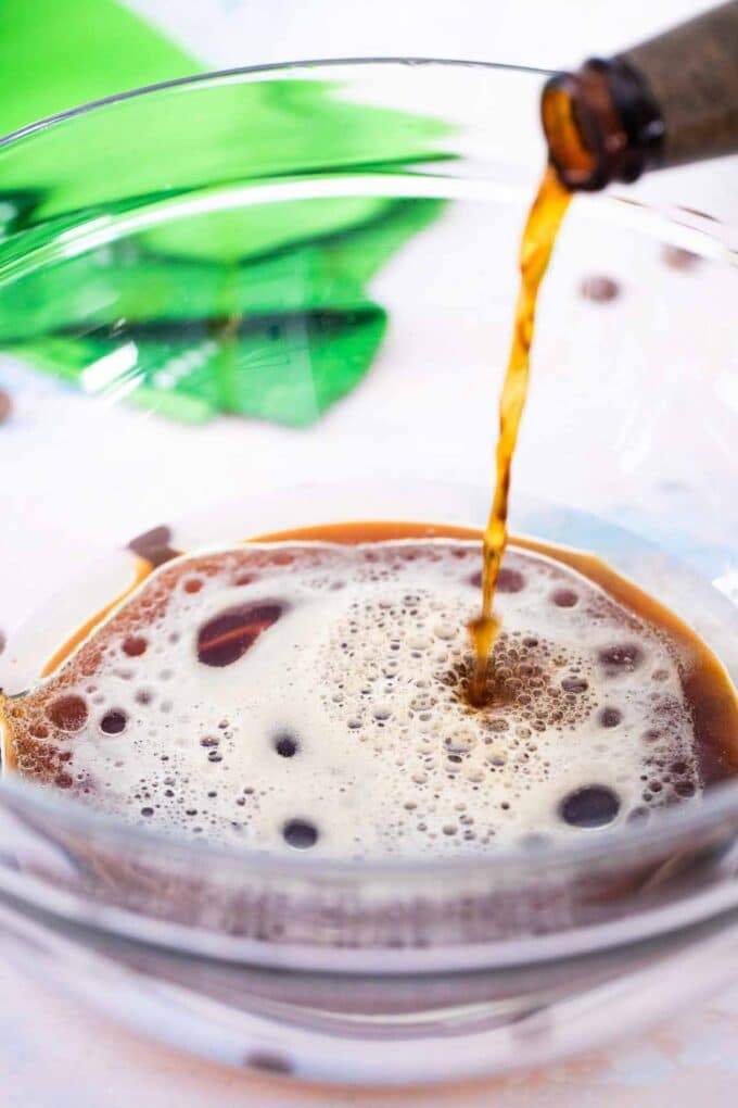 pouring Guinness beer in a large mixing bowl