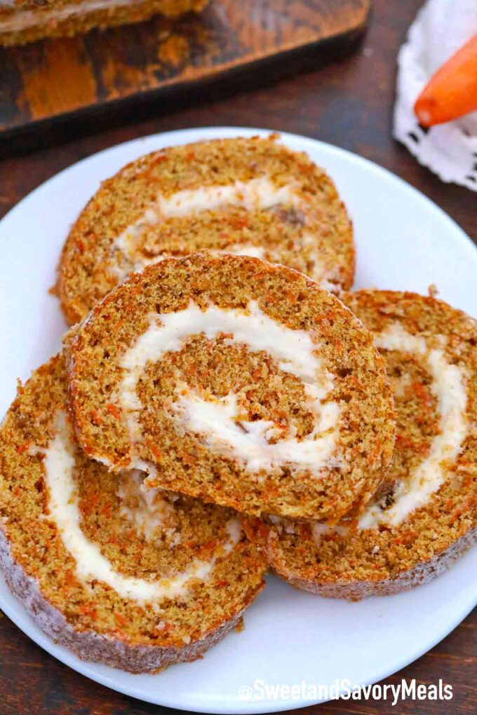 four slices of carrot cake roll on a plate