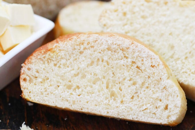 Sliced challah bread on a cutting board.