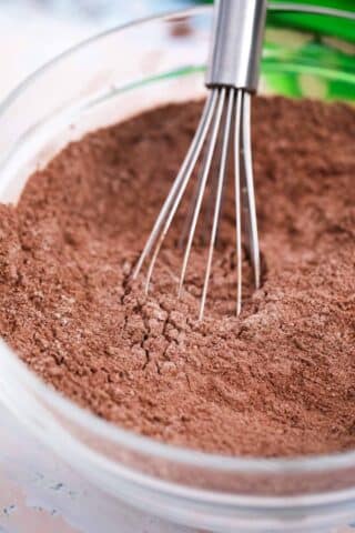 stirring cocoa powder in a mixing bowl