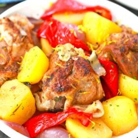 a bowl of roasted lamb with potatoes and bell pepper