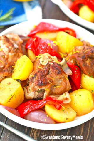 a bowl of roasted lamb with potatoes and bell pepper