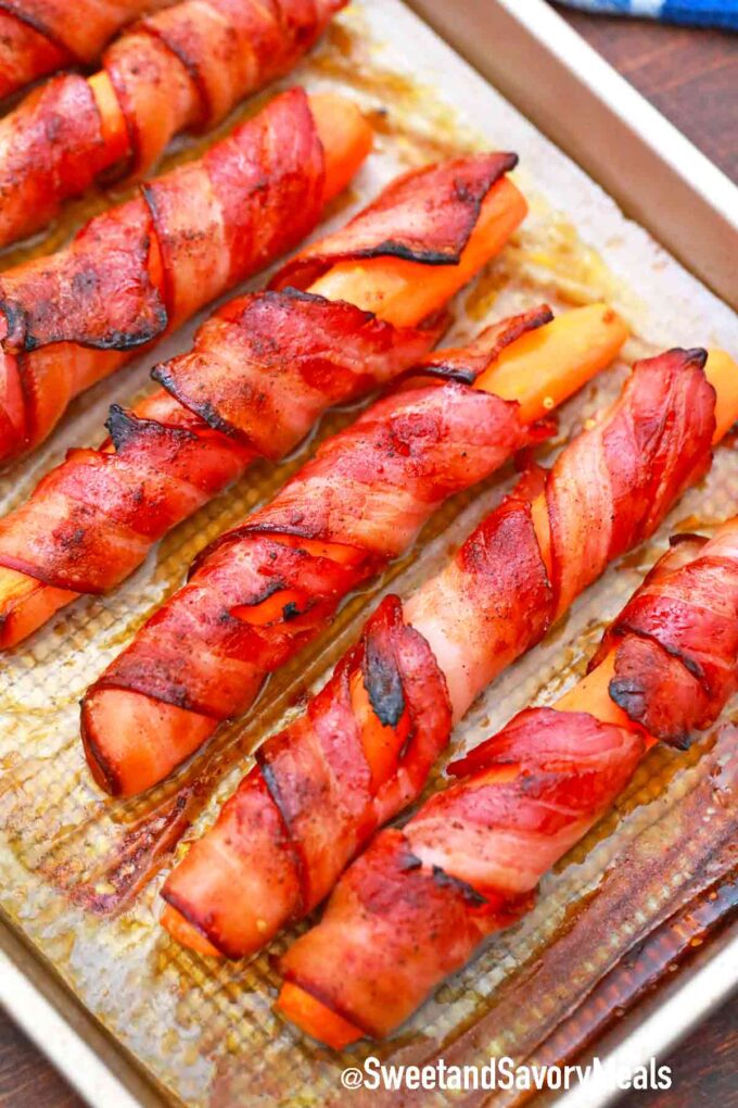 a baking sheet of bacon wrapped carrots