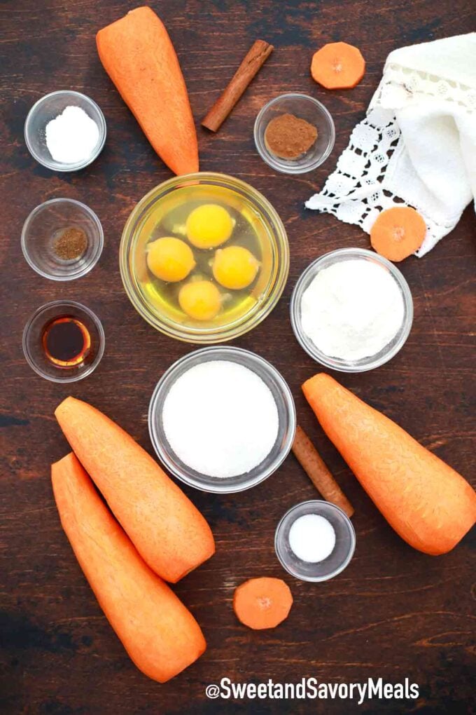 carrots and ingredients in bowls spread on a wooden table