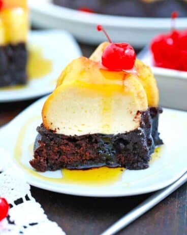 chocolate flan slice topped with a maraschino cherry