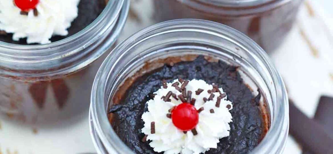 chocolate pots de crème topped with whipped cream