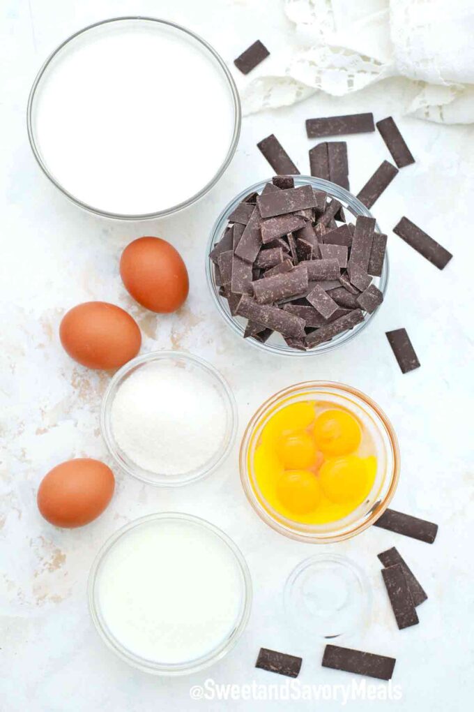 chopped chelate eggs and more ingredients in bowls on a white table