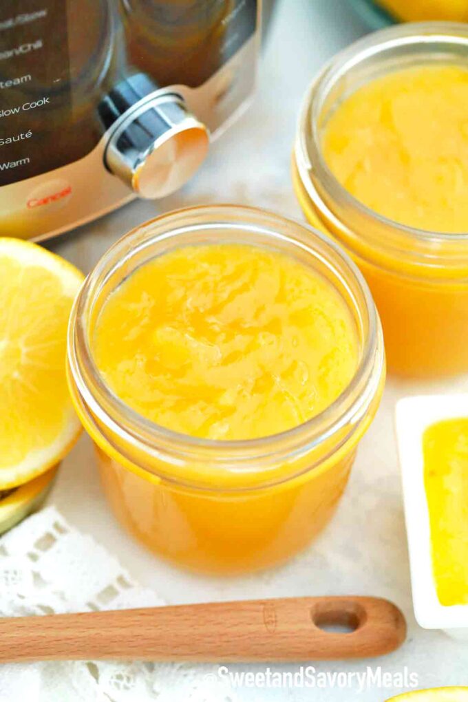 mason jars with lemon curd next to an instant pot