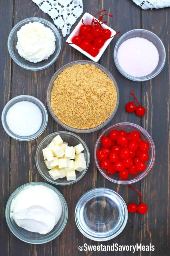 maraschino cherries graham cracker crumbs and other ingredients in bowls on a wooden table