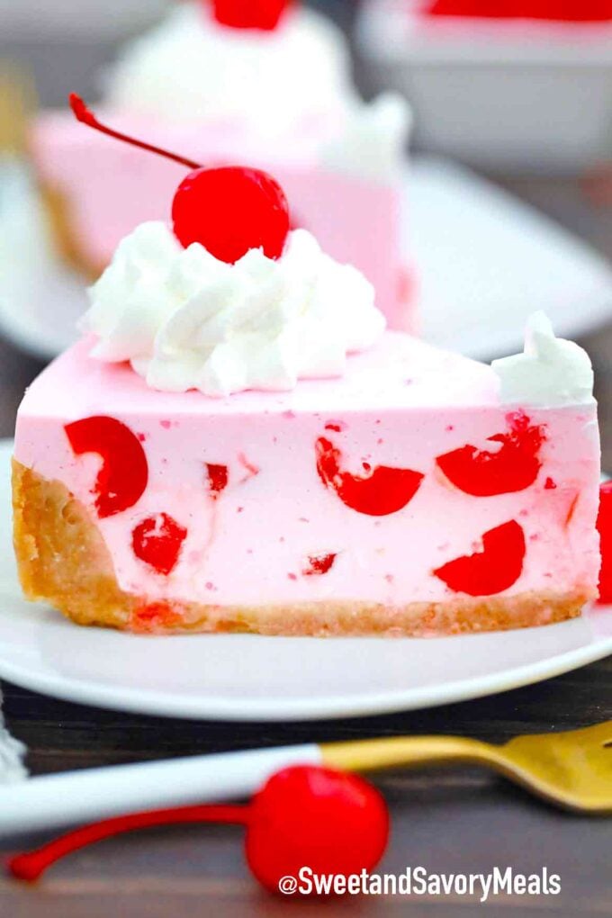 sliced maraschino cherry pie topped with whipped cream and a cherry