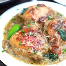 a plate of creamy and browned tuscan chicken