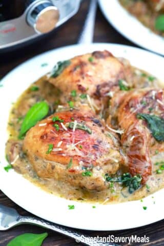 a plate of creamy and browned tuscan chicken