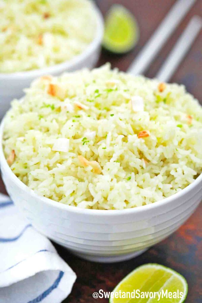 a bowl of fluffy coconut rice topped with lime zest and toasted coconut