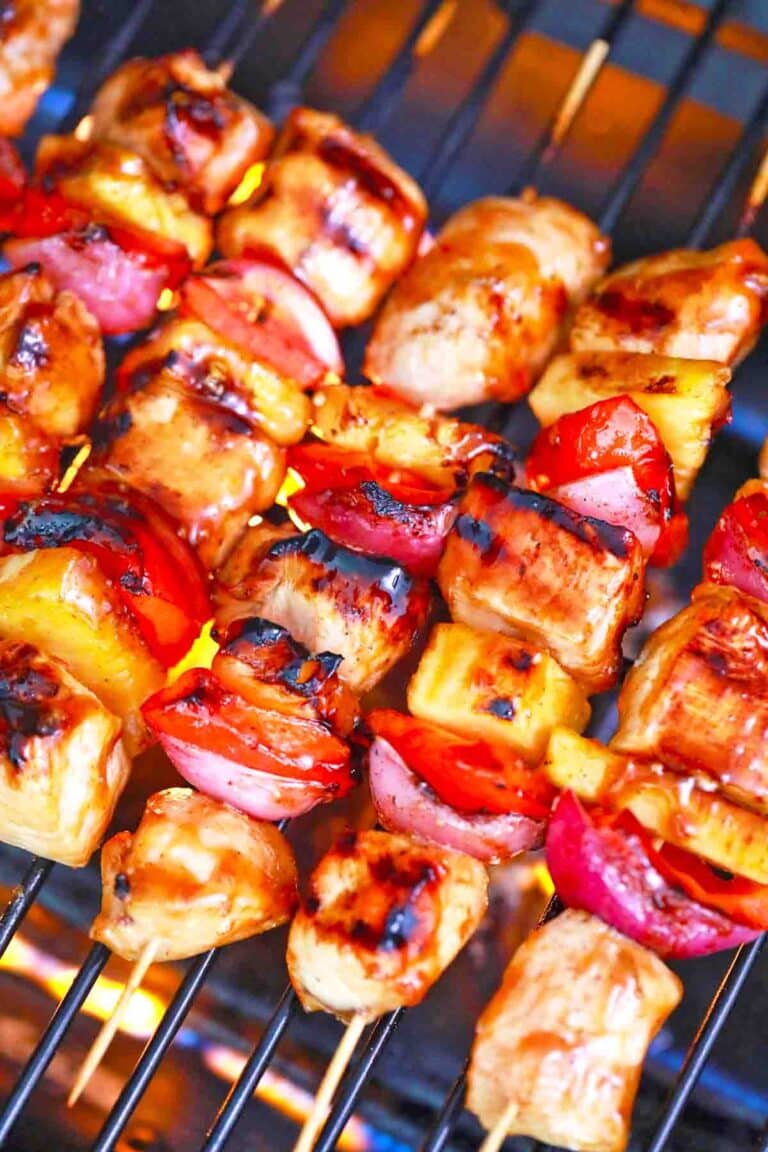 BBQ chicken kabobs cooking on an outdoor grill