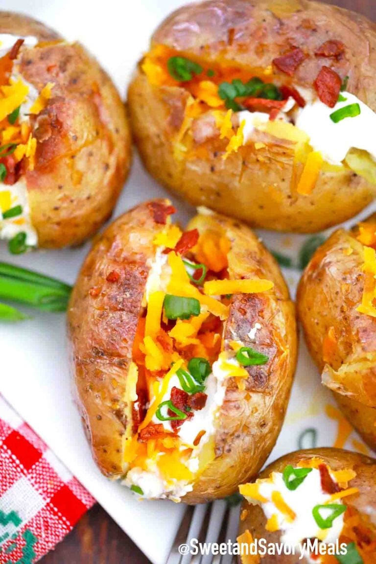 grilled baked potatoes with toppings on a serving plate