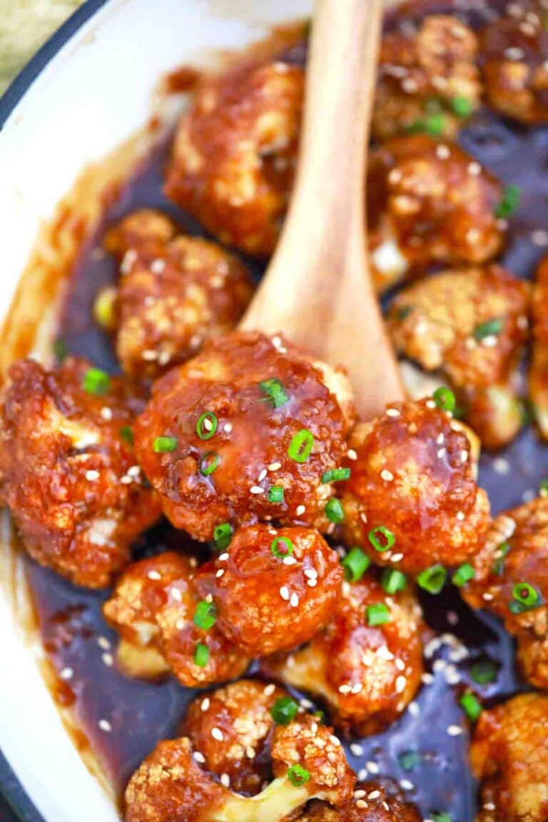 close shot of a spoonful of sticky sesame cauliflower in a sauce