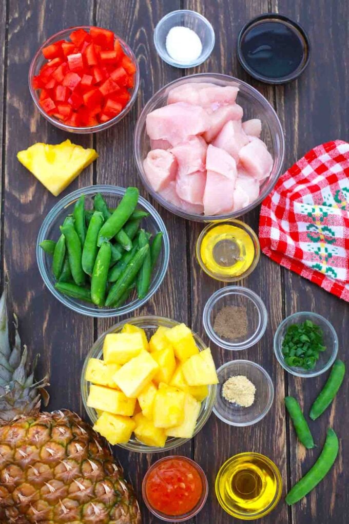 chicken pineapple and other ingredients in bowls on a table