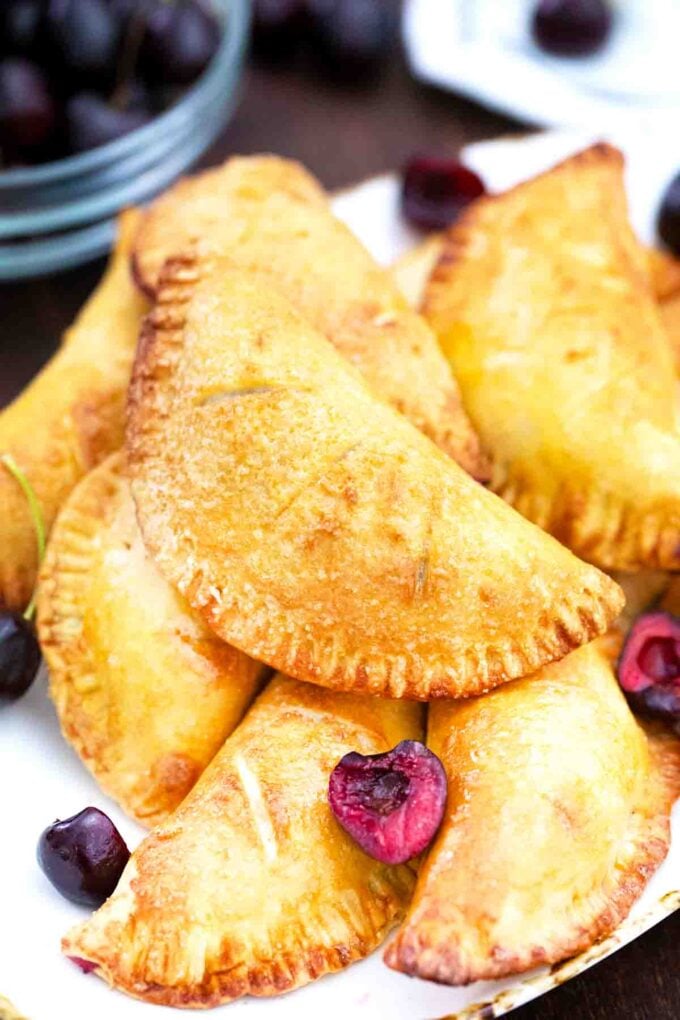 air fryer cherry hand pies stacked on a plate
