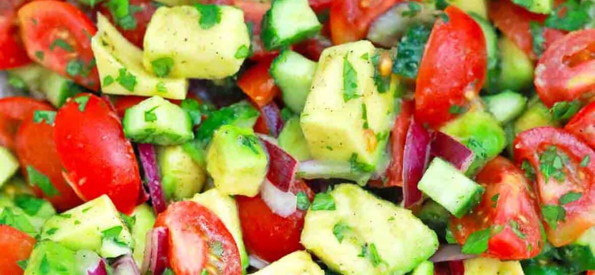 overhead shot of cucumber tomato avocado salad