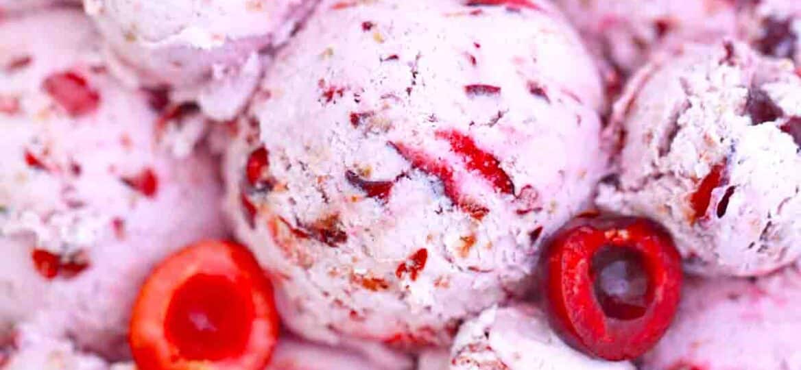 a bowl of homemade cherry ice cream with fresh cherries