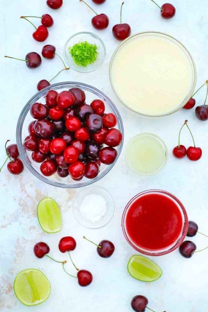 overhead shot of cherries cherry juice and condensed milk on a table
