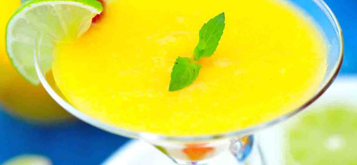 pineapple mango daiquiri garnished with lime and strawberry
