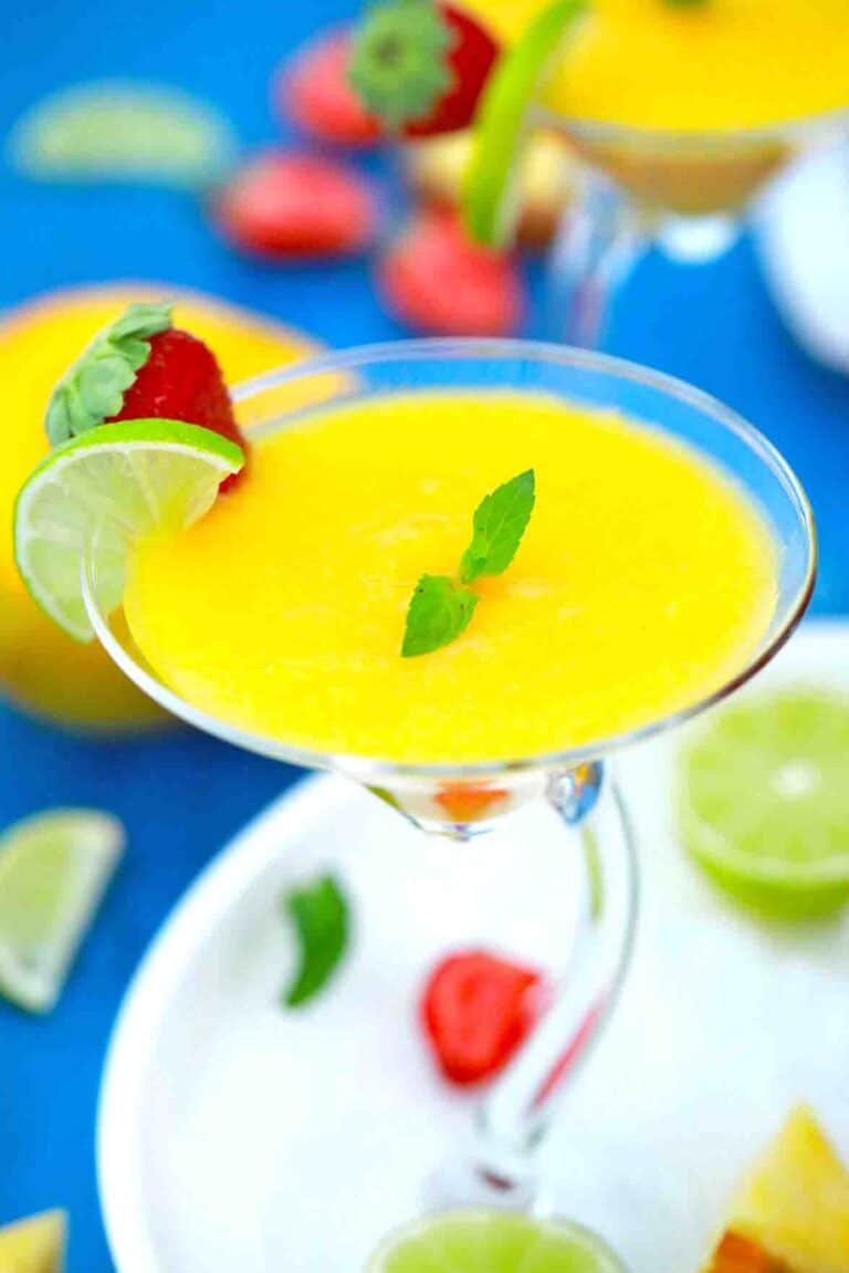 pineapple mango daiquiri garnished with lime and strawberry