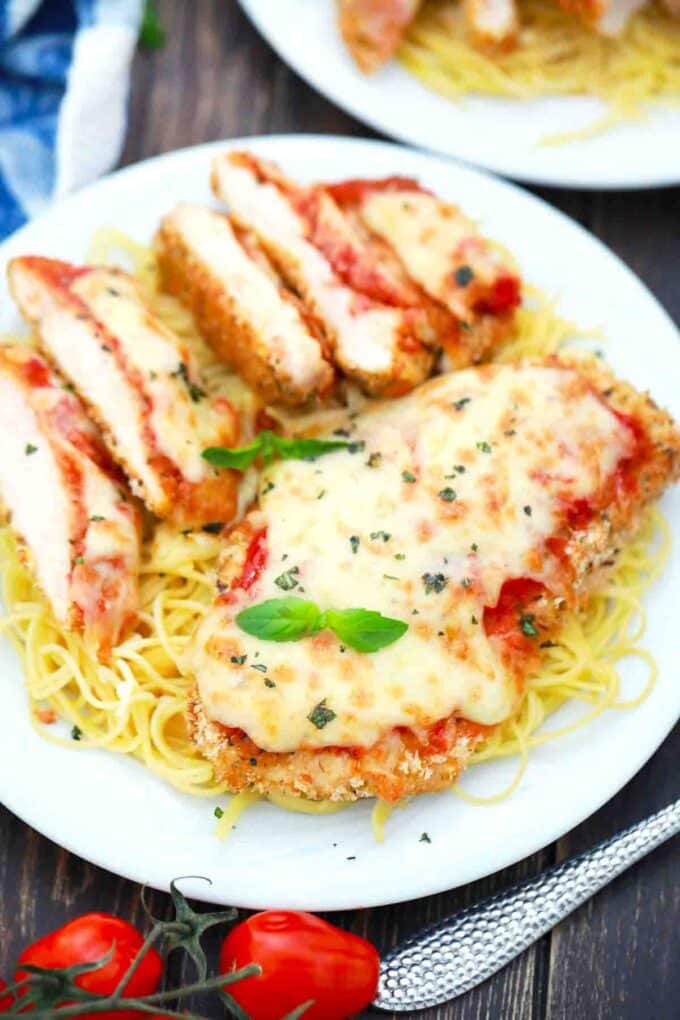 air fried chicken parmesan topped with melted cheese and basil