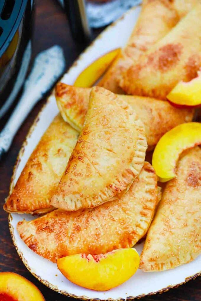 overhead shot of air fried peach hand pies arranged on a plate