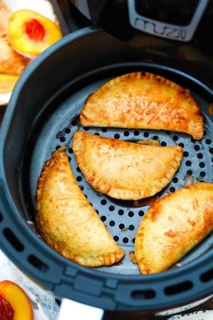 air fried peach hand pies in the air fryer basket