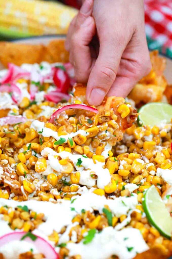 scooping mexican street corn nachos