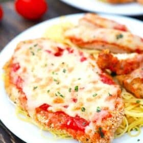 air fried chicken parmesan covered in cheese served with spaghetti