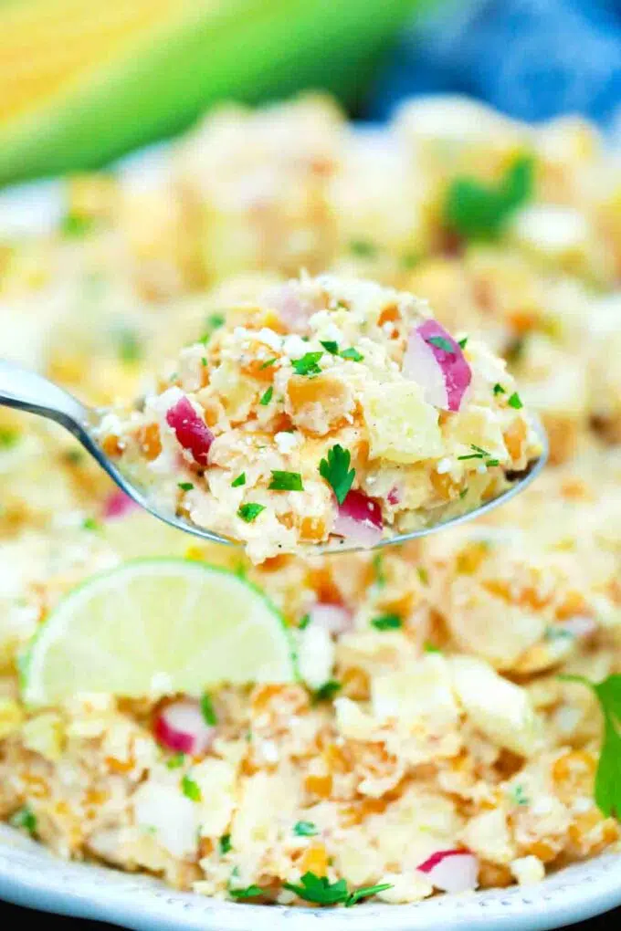 close shot of a spoonful of creamy mexican street corn potato salad
