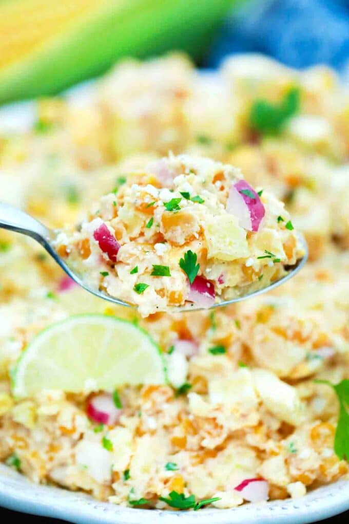 close shot of a spoonful of creamy mexican street corn potato salad