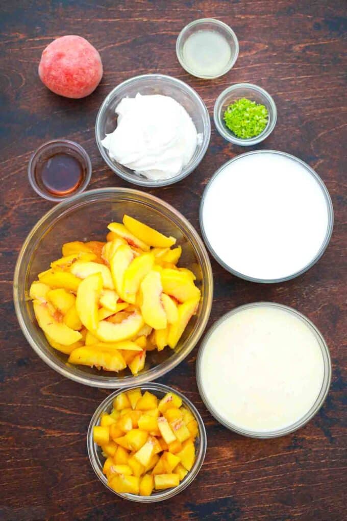 overhead shot of sliced peaches condensed milk whipped cream in bowls on a table